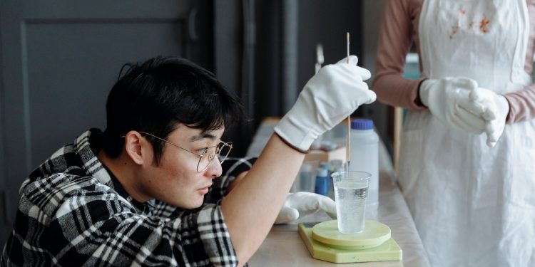 man-carefully-mixing-the-resin